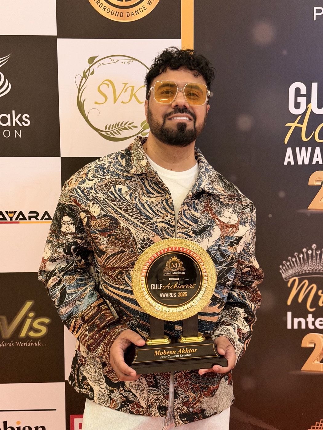 Mobeen Akhtar holding the Best Content Creator trophy at the Gulf Achievers Awards 2026